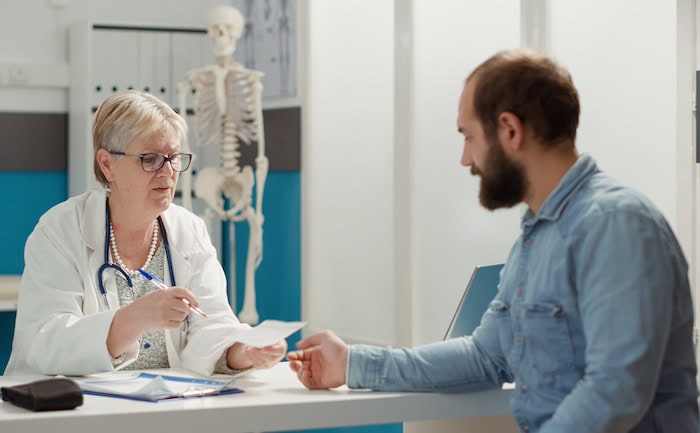 Ärztin mit Patient: Unter anderem gestaltet sich die Arztsuche für Menschen hierzulande schwierig, was das Vertrauen in das Gesundheitssystem untergräbt.