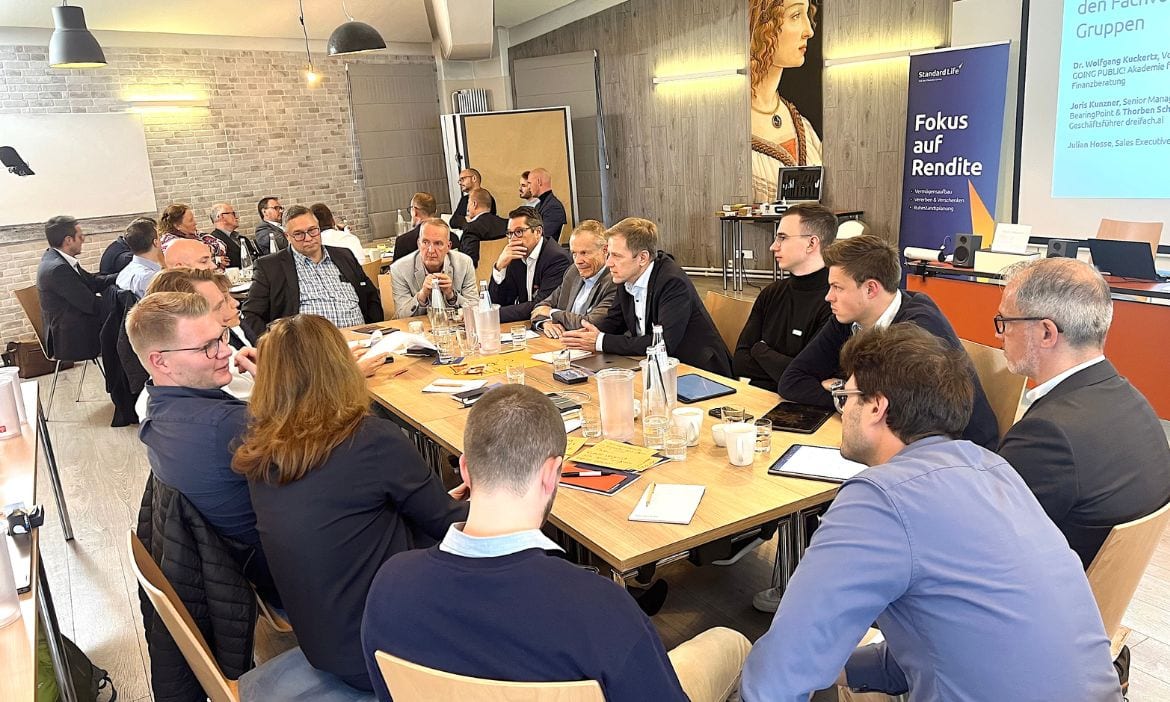 Am runden Tisch sitzen Makler und Makerbetreuer.