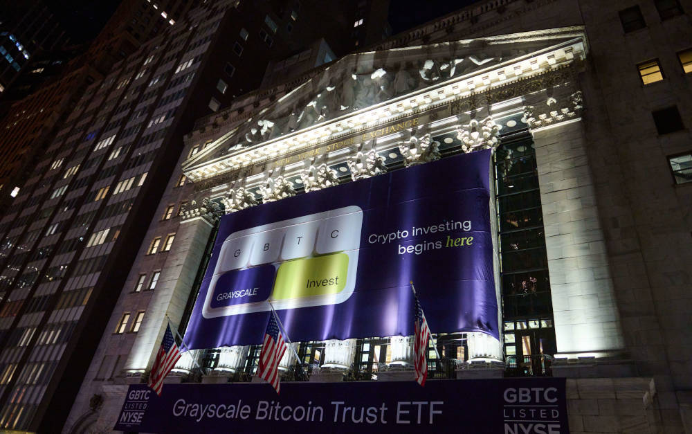 Banner mit Bitcoin-ETF von Grayscale im Februar 2024 an der Fassade der Börse in New York: Bitcoin-ETFs sammelten 2024 Milliarden ein